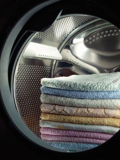 Colourful towels folded inside a washing-machine drum